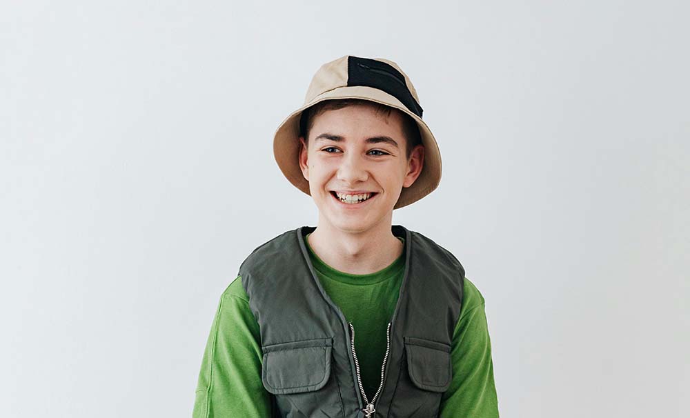 young lad smiling, about to learn fly fishing